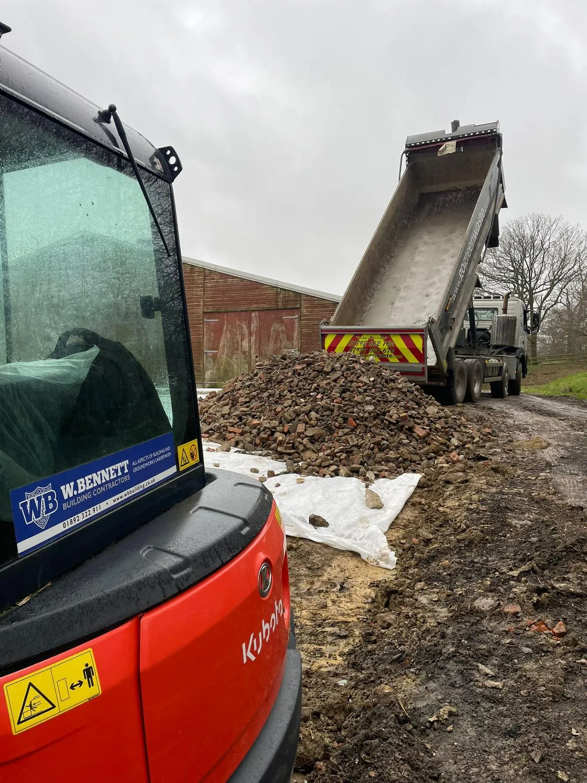 A dump truck is parked next to a dump truck.