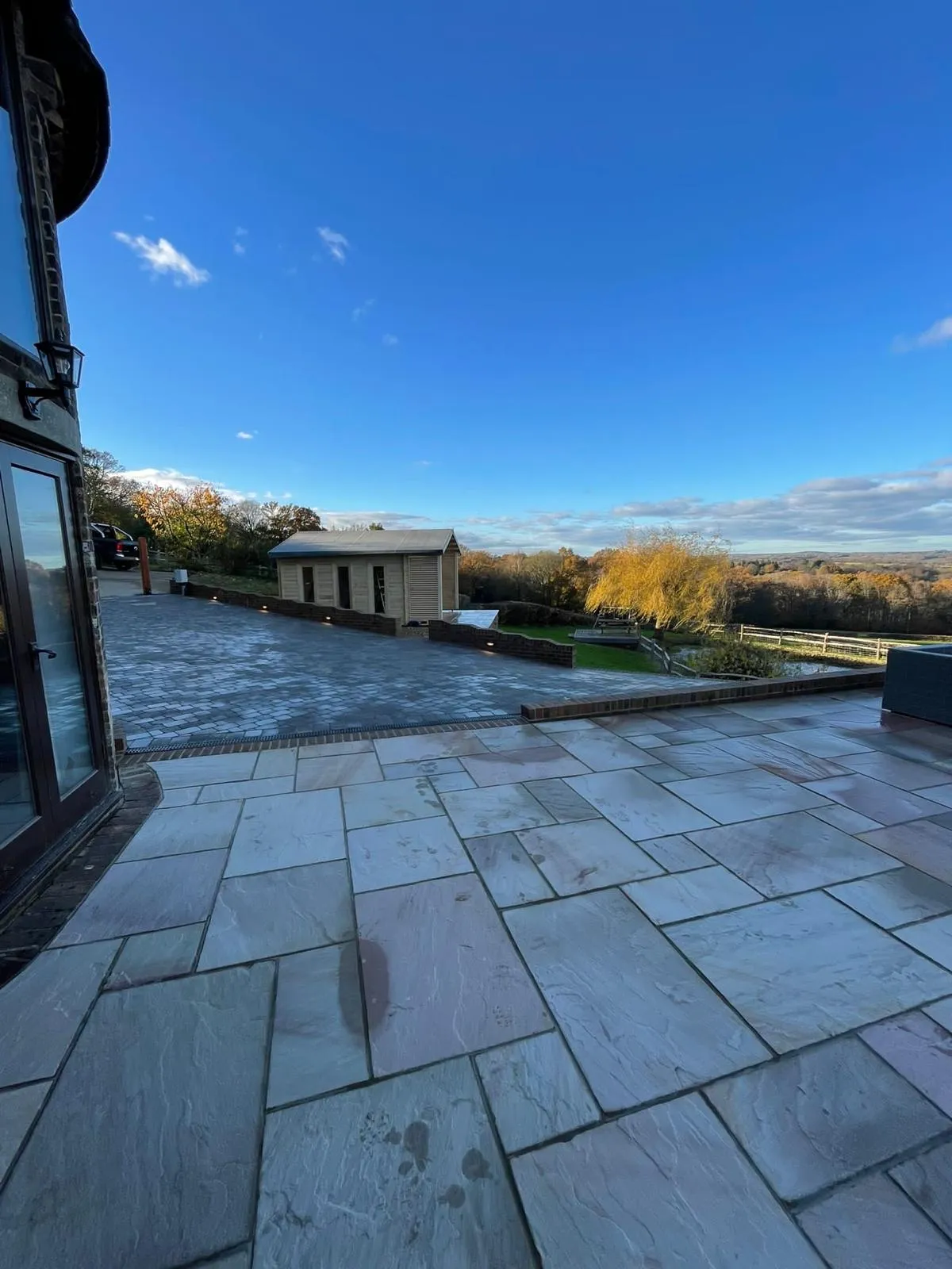 A patio with a view of the countryside.